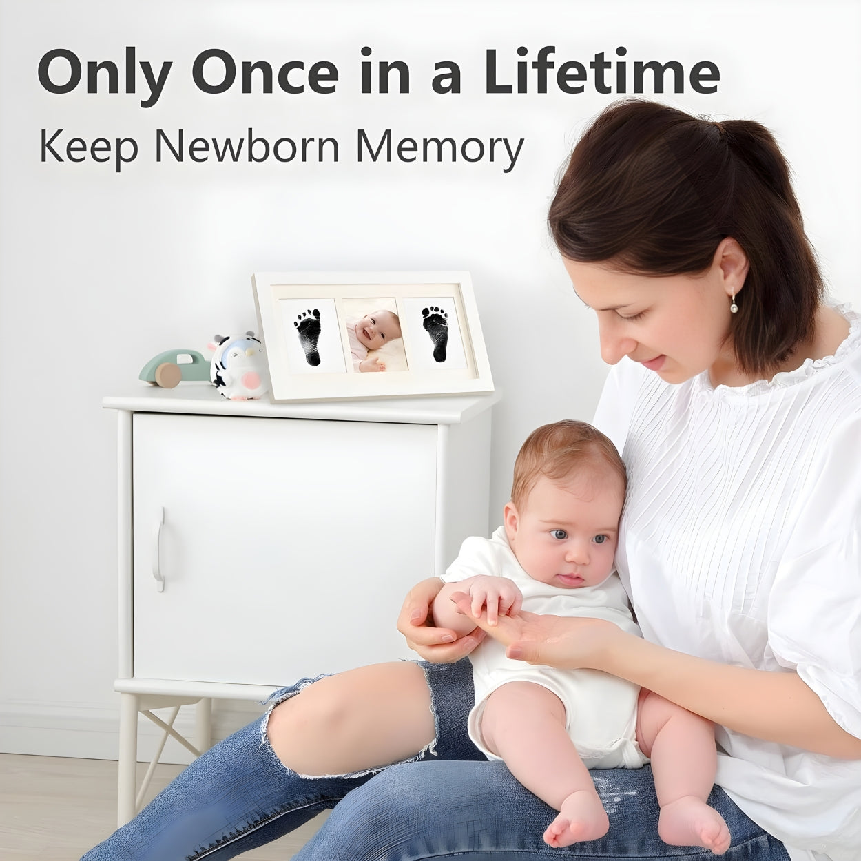 Woman holding a baby with framed baby pictures and footprints on a shelf - Little Treasures
