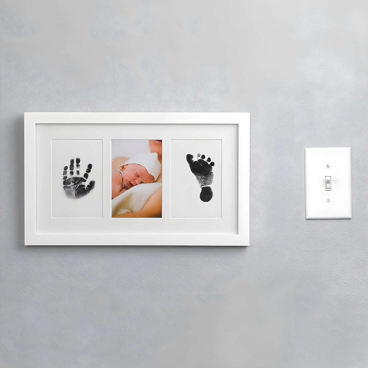 White photo frame with baby hand and footprints on a gray wall - Little Treasures